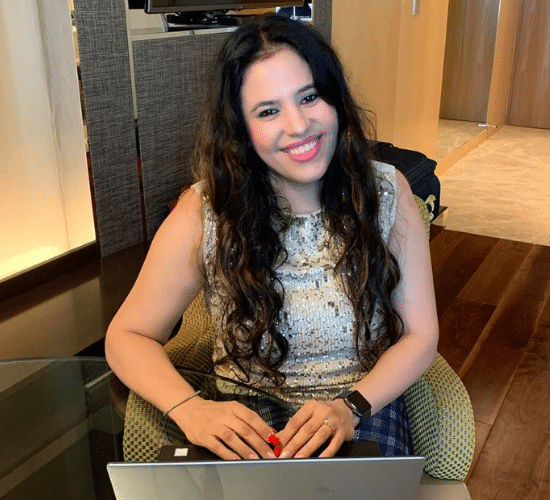 Parleen singh smiling, laptop in hand